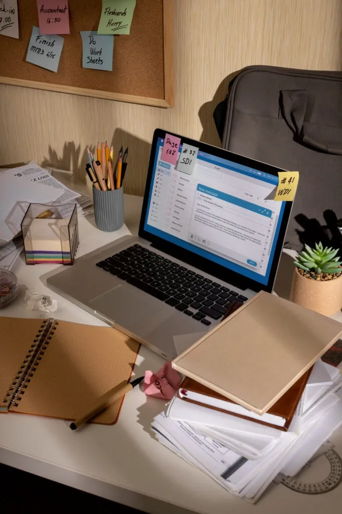 Cluttered desk with laptop, notes, and papers; Law Firm Content Marketing